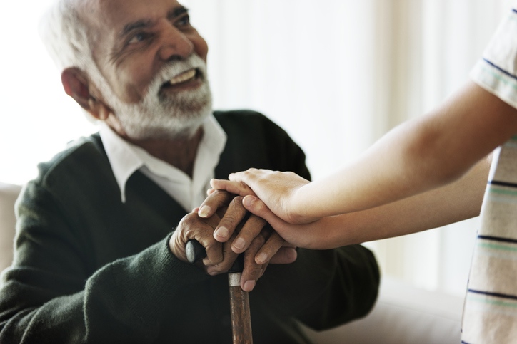 An old man hold girls hand, symbolizing connection in hospice and palliative care in a skilled nursing facility in Shreveport, LA