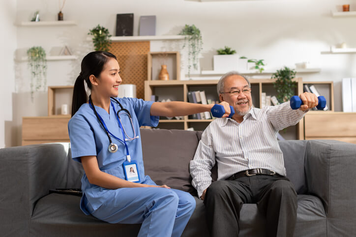 During skilled nursing care in Shreveport, LA, a nurse and patient perform weightlifting exercises