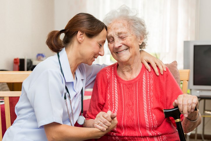 Nurse assists elderly woman with walker in Shreveport, LA, highlighting Long-Term Care Services